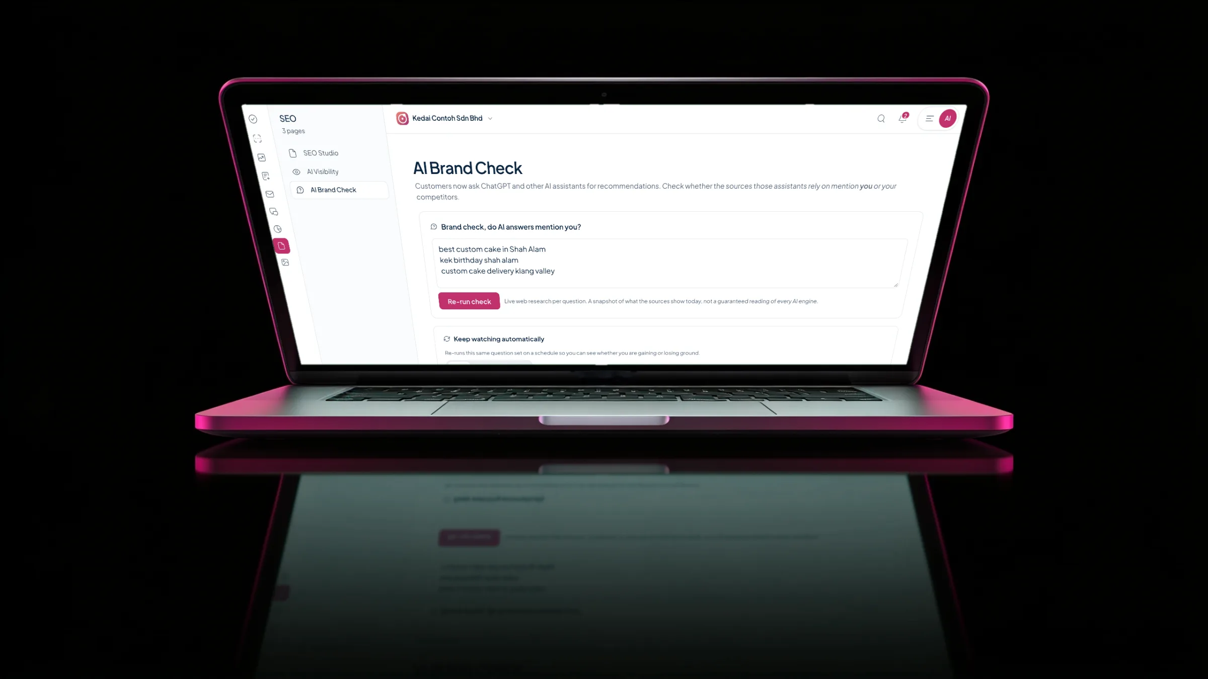 A laptop with a berry rim light on black showing AI Brand Check: three questions customers ask an AI assistant about custom cakes, and a Re-run check button