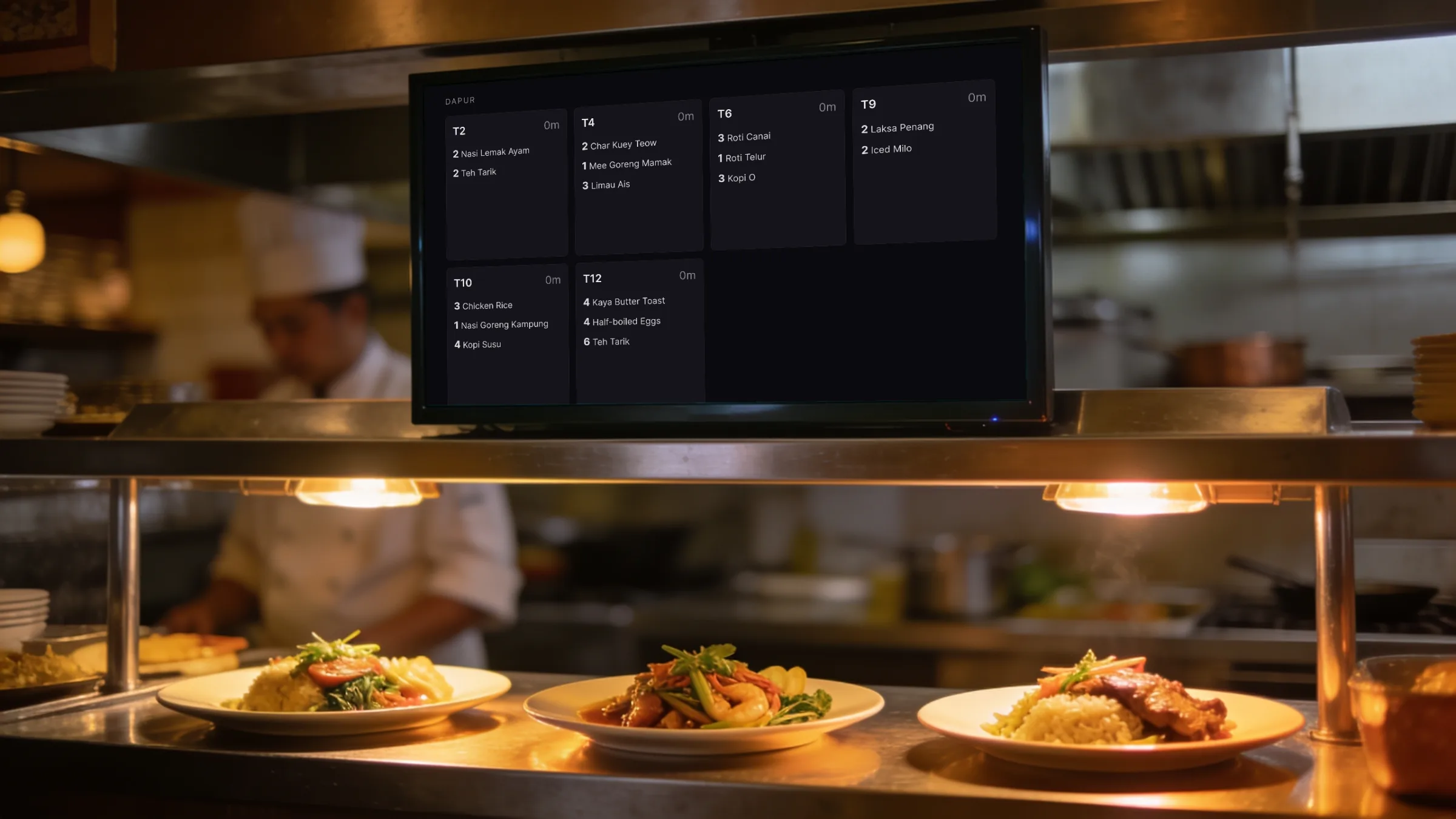 A screen above a restaurant kitchen pass showing the Orbit POS kitchen display: six table orders with their items, over plated dishes under heat lamps